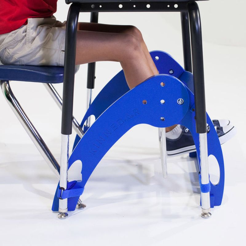 Kinnebar Foot Swing K100 in blue, side view showing adjustable aluminium bar and HDPE base, an under-desk sensory focus tool for classrooms