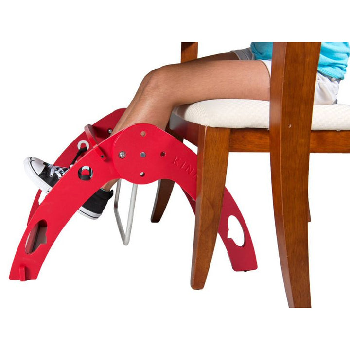 Kinnebar Foot Swing K200 in red, a durable HDPE under-desk sensory foot swing for children and adults in classrooms and at home