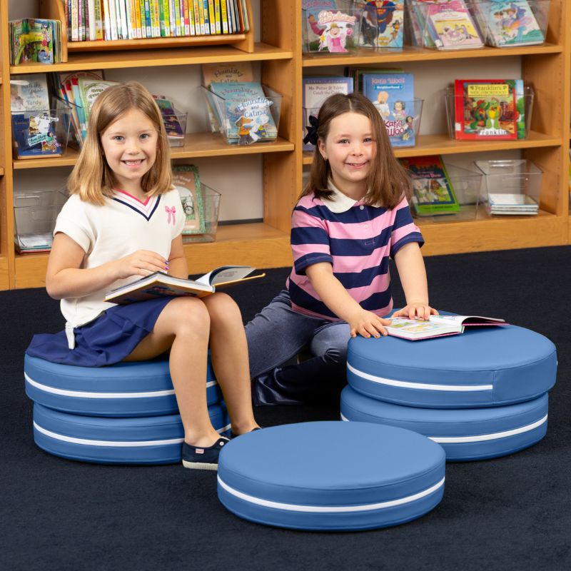 Two children reading in a school library while seated on Jaxx Kirkwood blue stacking floor cushions