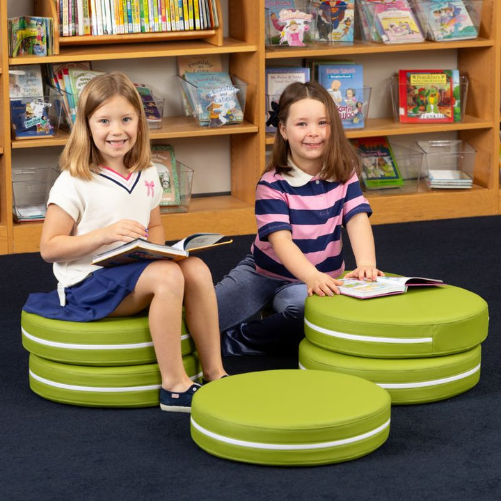 Two children reading in a school library while seated on Jaxx Kirkwood green stacking floor cushions