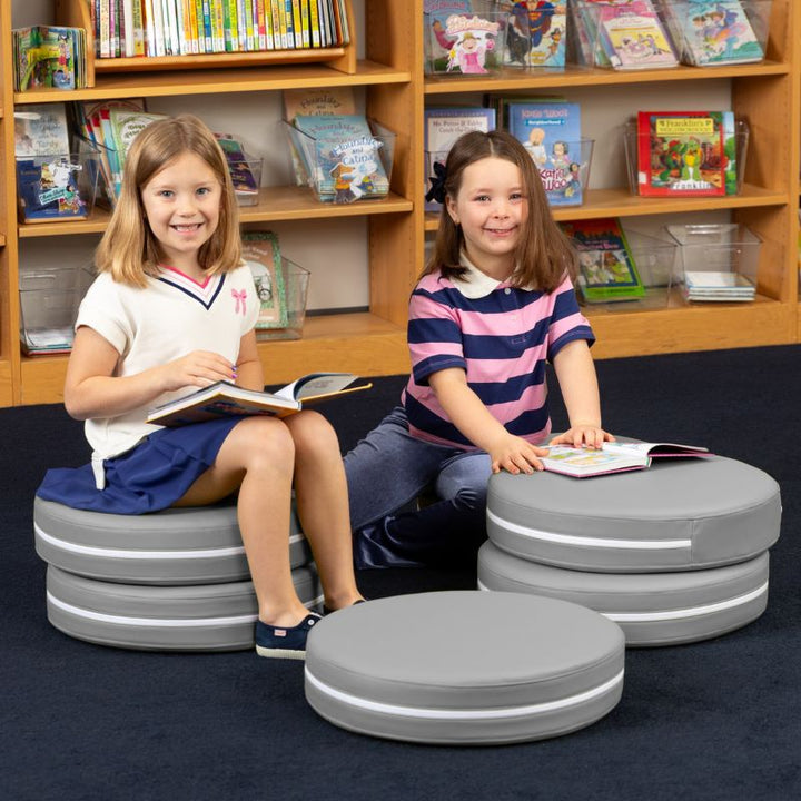 Two children reading in a school library while seated on Jaxx Kirkwood grey stacking floor cushions