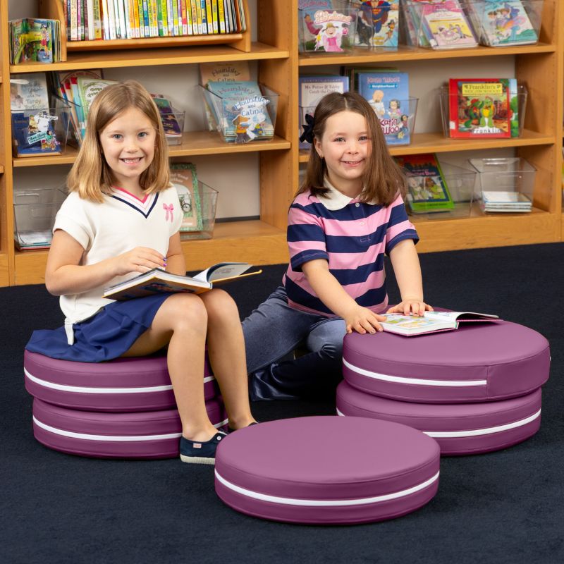 Two children reading in a school library while seated on Jaxx Kirkwood purple stacking floor cushions
