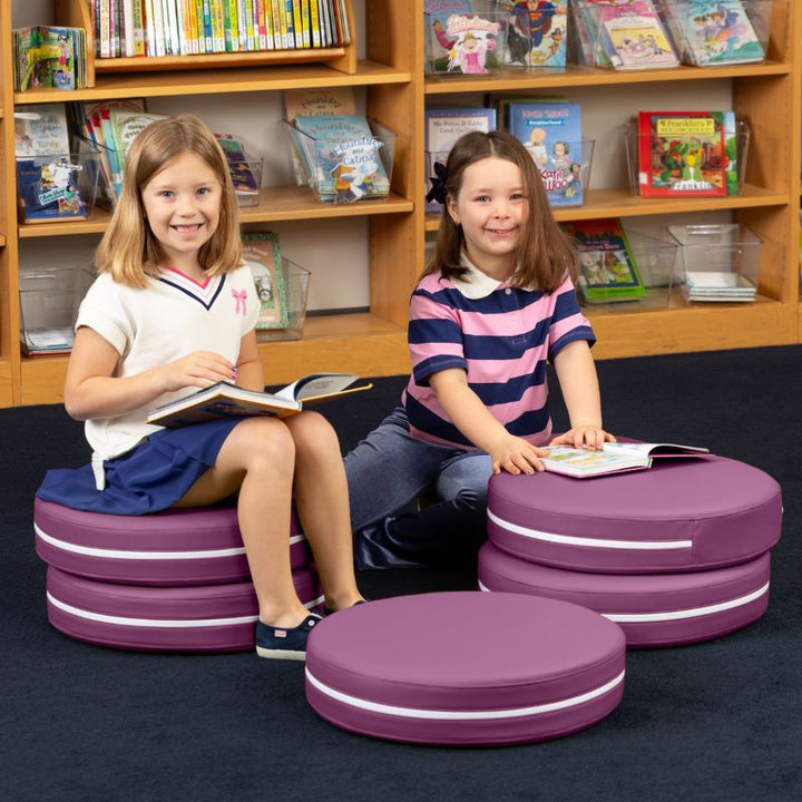 Two children reading in a school library while seated on Jaxx Kirkwood purple stacking floor cushions