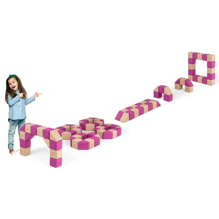 A child points to a row of arches, bridges and hexagon shapes built from the JollyHeap Fun Set magnetic building blocks in magenta and tan