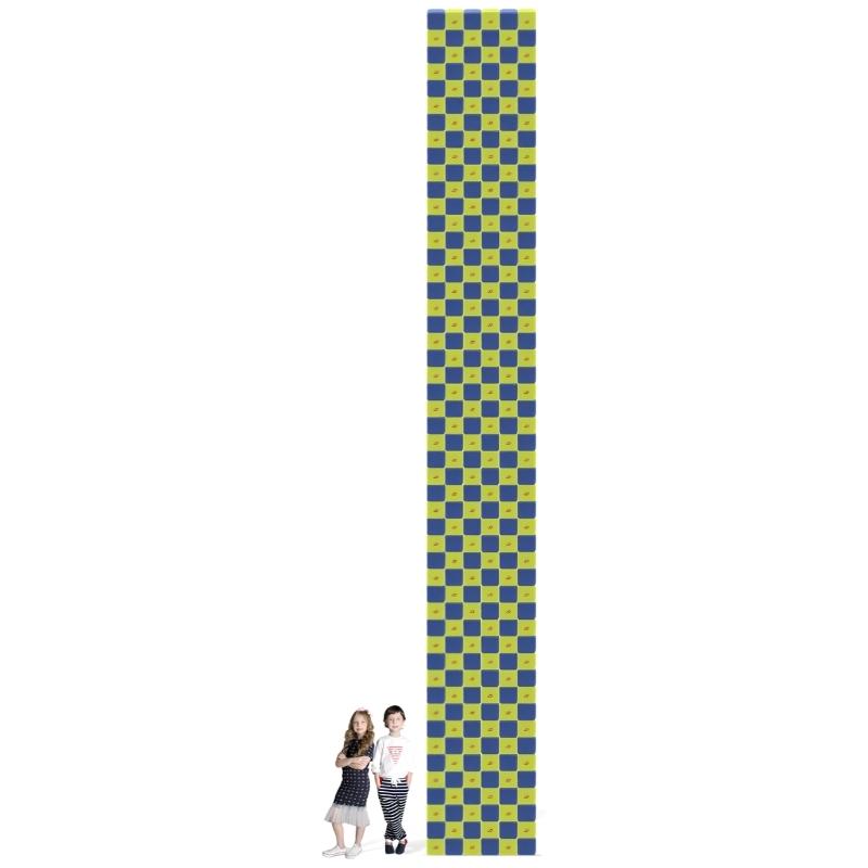 Two children stand beside a tall checkerboard tower built from the JollyHeap Fun Set large group magnetic building blocks, showing scale