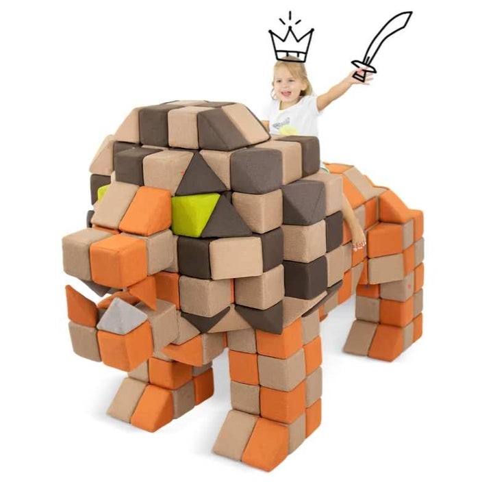 Child riding a dinosaur structure built from the JollyHeap large magnetic foam block set