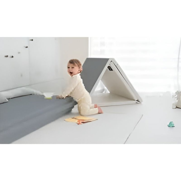 Child actively playing on the Licoco Clean Roll Playmat Plus Single Coating Gray 200x140cm, demonstrating the safe cushioned surface for crawling, rolling, and early gross motor development