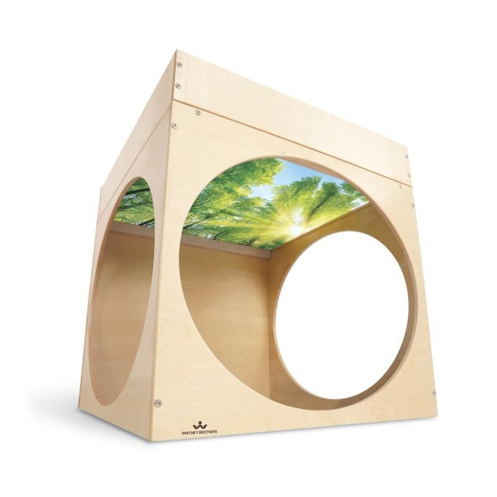 Whitney Brothers Superbright LED Creative Cube in birch plywood, with circular openings revealing the printed forest canopy inside this light table reading cube and calm corner