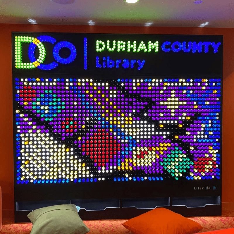 LiteZilla Giant Lite Brite front view showing the fully illuminated interactive light wall with a completed LitePin design in vibrant colours