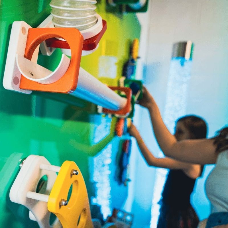 Close-up detail of LiteZilla MagWiz Magnet Wall magnetic components showing interactive sensory gear or ball-run elements
