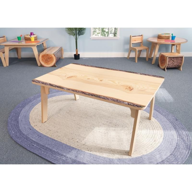 Whitney Brothers Nature View Live Edge Activity Table in rectangle shape on a classroom rug, a nature-inspired preschool table with realistic wood grain and bark edges