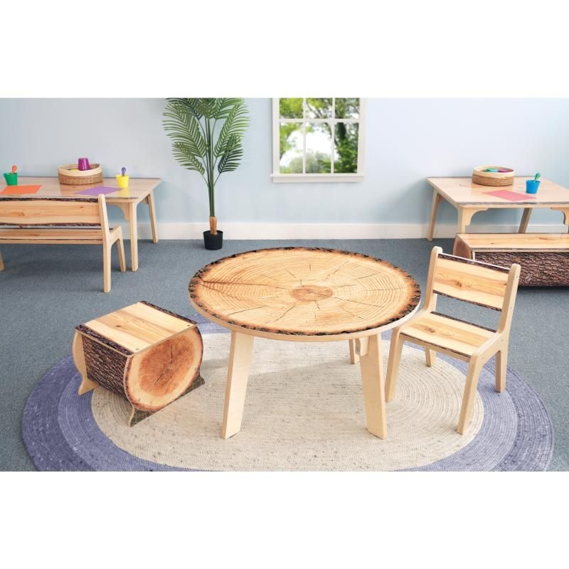 Whitney Brothers Nature View Live Edge Activity Table in round shape with a log stool and Live Edge chair, creating a cozy nature-themed reading space