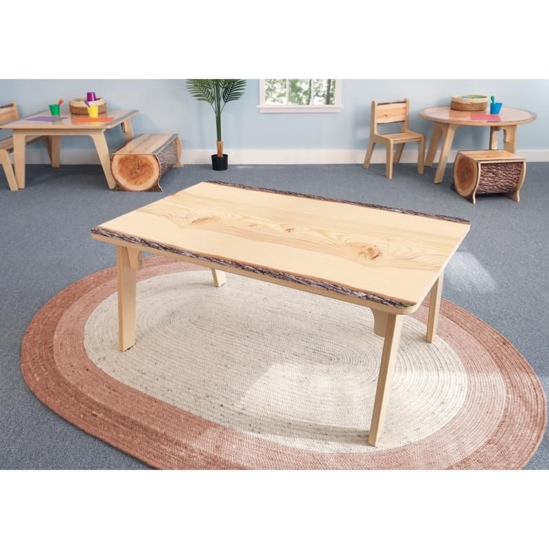 Whitney Brothers Nature View Live Edge Rectangle Table 18H on a round terracotta rug in a nature-themed preschool classroom with log stools and matching chairs