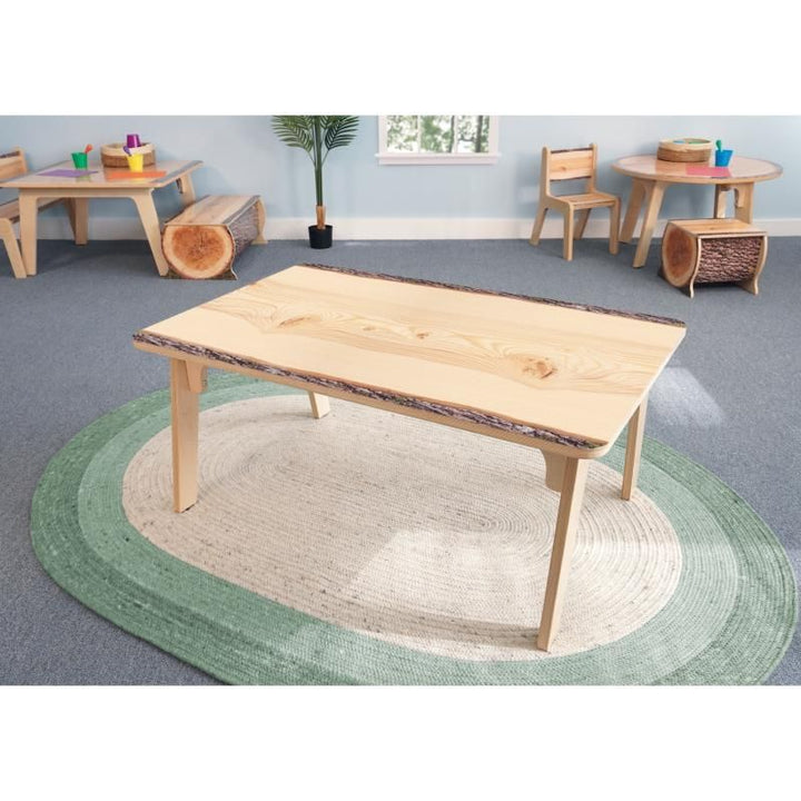 Whitney Brothers Nature View Live Edge Rectangle Table 22H on a green oval rug in a bright classroom, biophilic furniture for early learning spaces