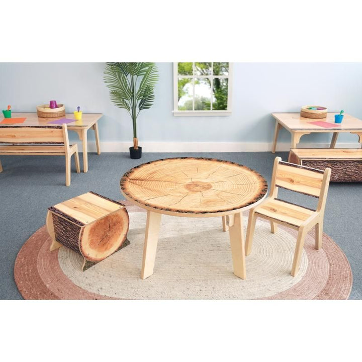 Whitney Brothers Nature View Live Edge Round Table 18H paired with a Live Edge log stool and wooden chair, nature-inspired classroom furniture for a cozy reading corner