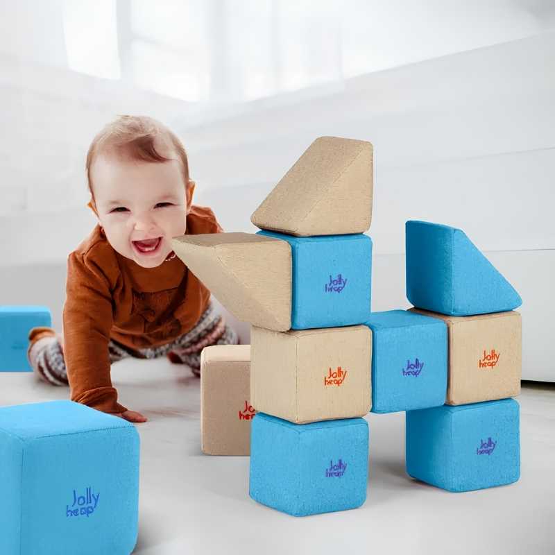 Baby playing with JollyHeap Pixi soft magnetic building blocks stacked into a tower