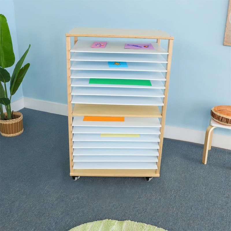 Whitney Brothers Mobile Art Drying Rack holding colorful children's artwork in a bright playroom, a classroom art drying rack that works just as well at home