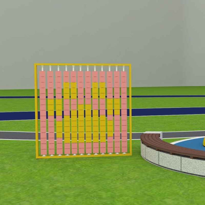 LiteZilla Mosaico Wall rotating wall panel installed near an outdoor playground with pink and yellow square tiles