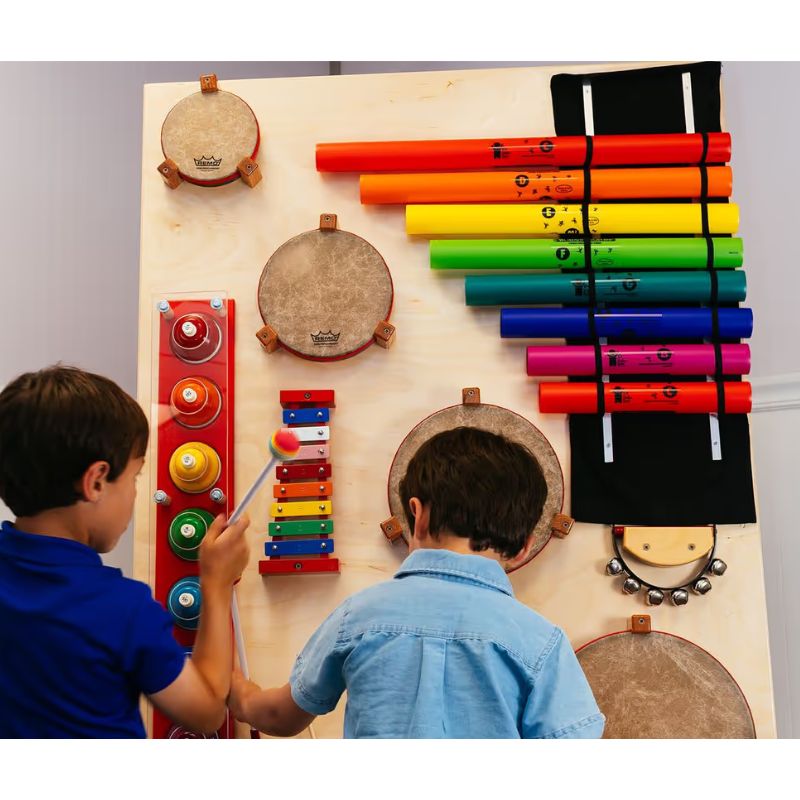 Two children playing the TFH Percussion Junction Wall Panel, a musical instrument wall panel with boomwhackers, drums and xylophone for sensory rooms