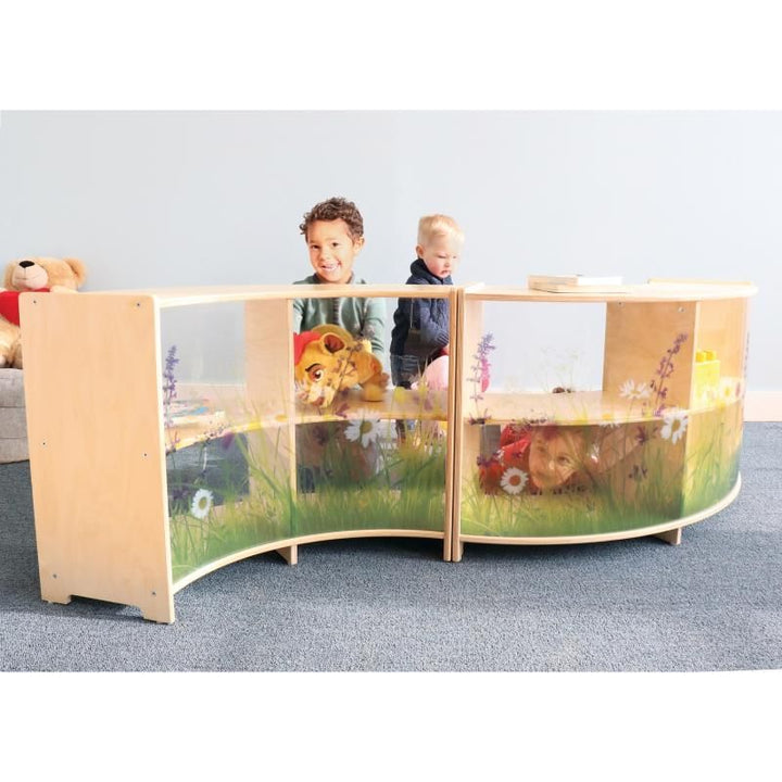 Two children look over a pair of Whitney Brothers Nature View Curve Cabinets forming a curved daycare room divider with a nature-inspired acrylic back