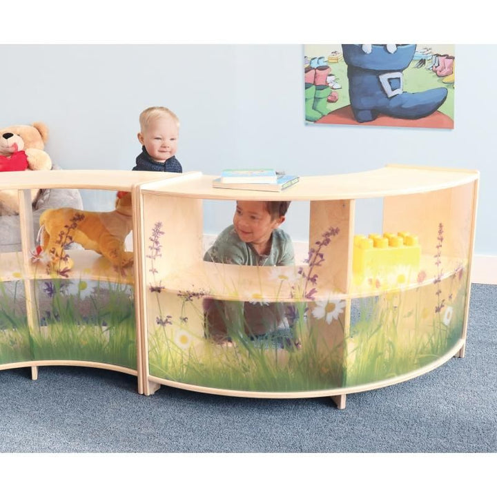Toddlers explore around connected Whitney Brothers Nature View Curve Cabinets, with books and blocks stored on top as toddler storage