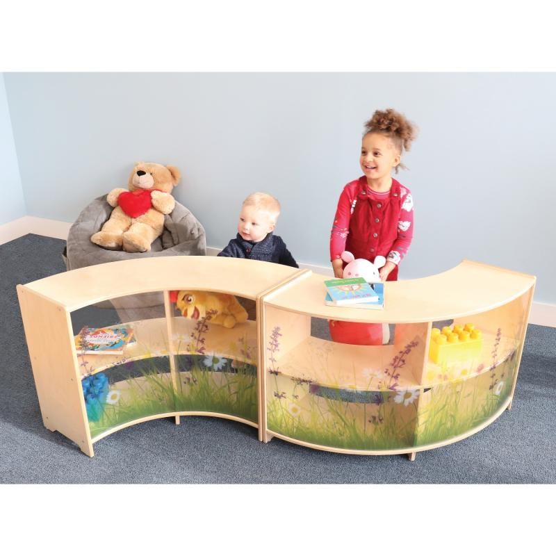 Two children play beside a pair of Whitney Brothers Nature View Curve Cabinets joined in a wave-shaped toddler room divider layout