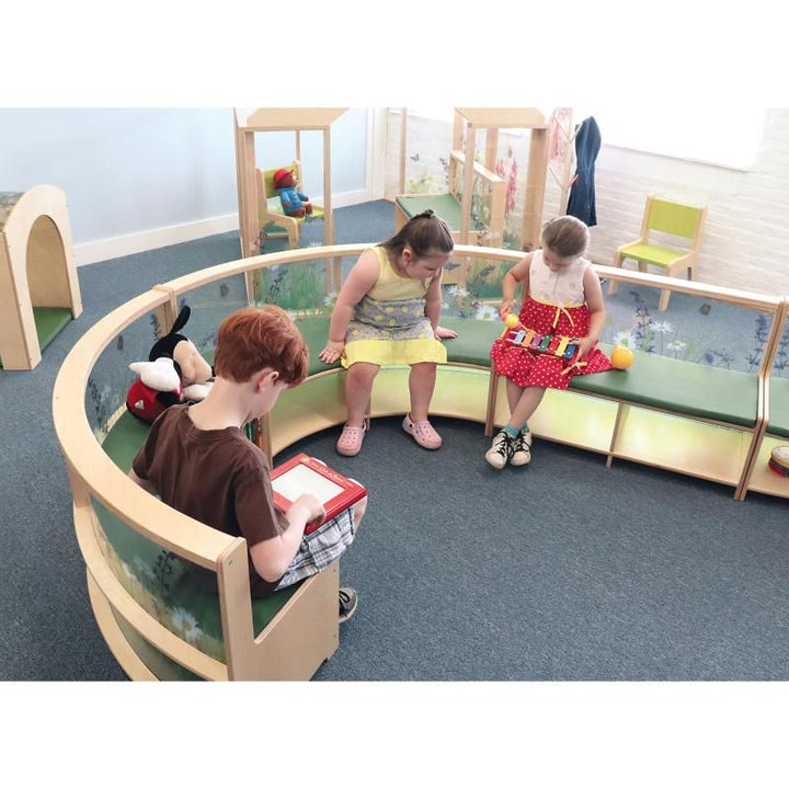 Children reading and playing on Whitney Brothers Nature View Curved Sofas arranged in a circle, a calm classroom reading nook