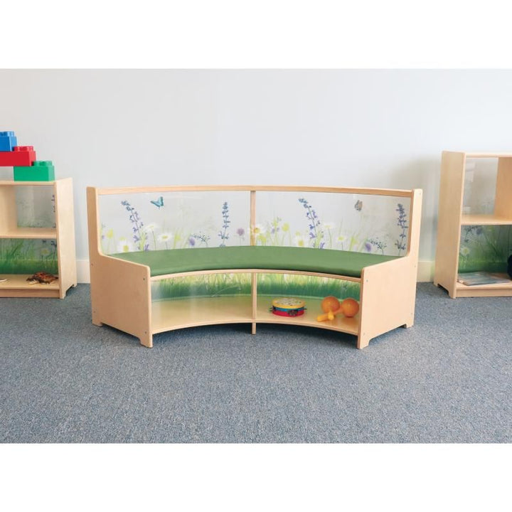 Whitney Brothers Nature View Curved Sofa curve-in style with a green seat cushion and book storage in a classroom reading nook