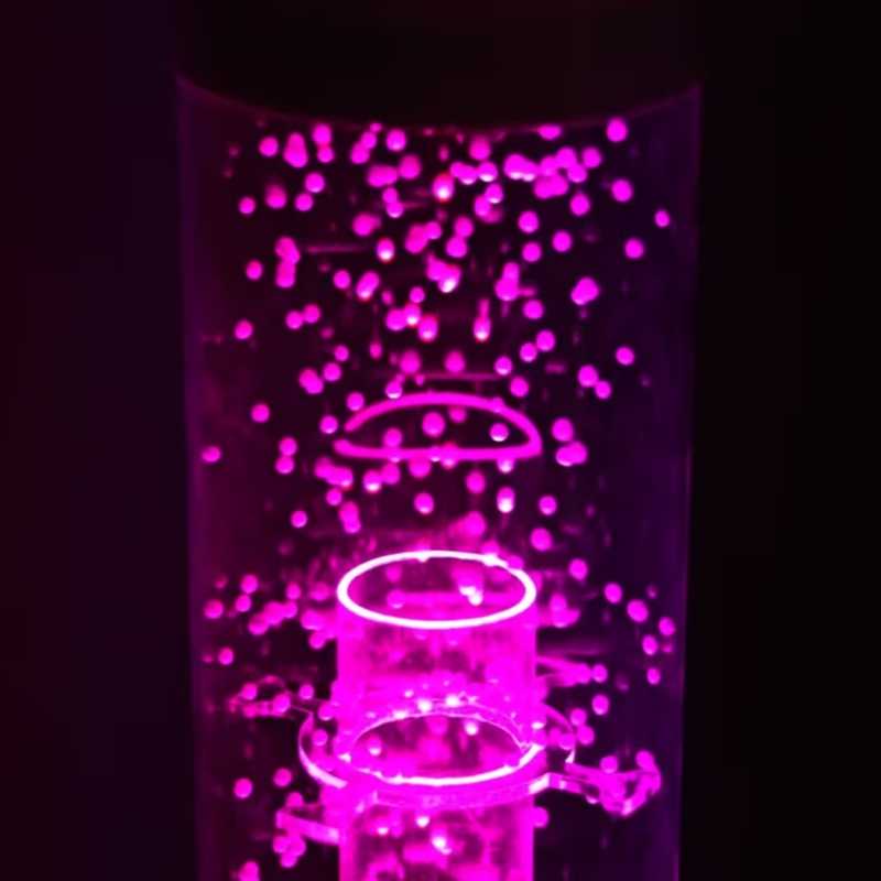 OMI Vecta Budii Delight bubble tube glowing pink up close, a mobile sensory station feature offering visual and tactile stimulation