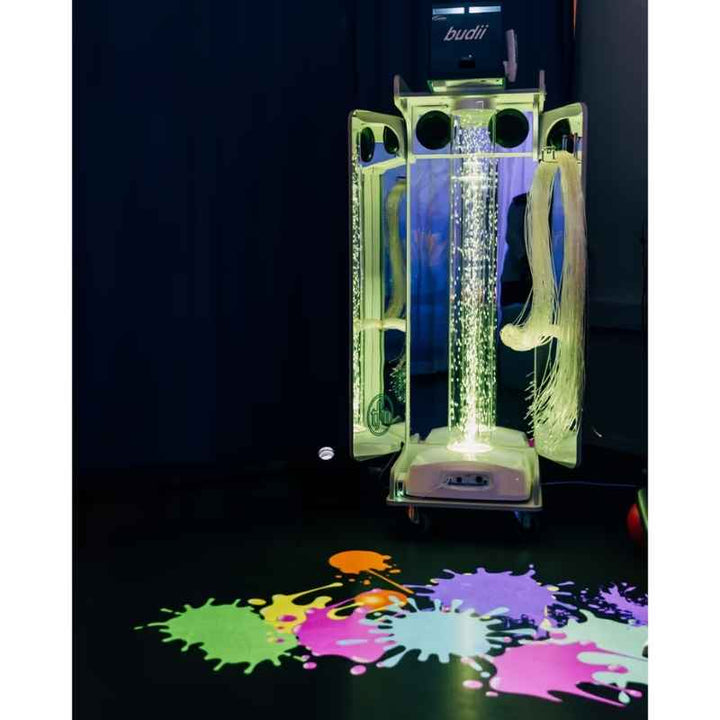 OMI Vecta Budii Delight sensory station in green light showing the budii interactive projector, fibre optic tails and a colourful floor projection