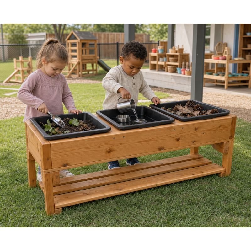 Two children using the ONP 3 Bin Sensory Table outdoors, pouring water and scooping soil across three separate play bins