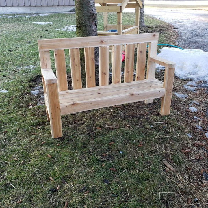 ONP Infant Buddy Bench outdoor view showing the full North American Cedar construction, 48-inch length, and taller armrests of this cedar outdoor infant bench designed for infant rooms and early years outdoor play spaces