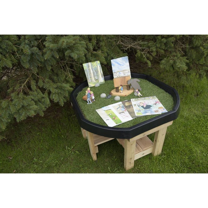 ONP Infant Active World Tray Stand 12" shown with accessories demonstrating the black Tuff Tray and cedar lower shelf in an outdoor early years sensory play and small-world provocation setting