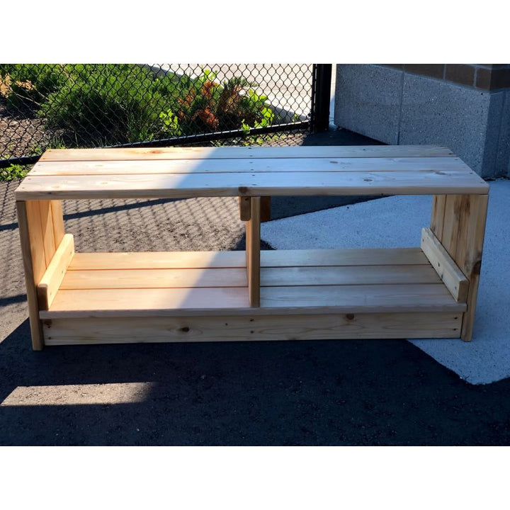 Children sitting on the ONP Outdoor Bench with Storage in an outdoor early years setting, showing the 18-inch height and 48-inch cedar bench proportioned for toddler and preschool-age group seating across Canada and the US