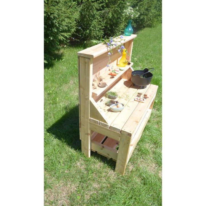 Side view of the ONP Outdoor Creative Concoction Table showing the cedar frame and preschool-height work surface, designed for mud pie corners and outdoor dramatic play across Canada and the US