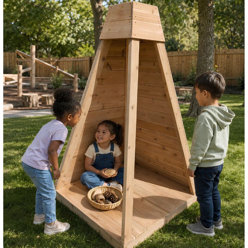 A girl sitting inside the pyramid-shaped ONP Outdoor Reading Nook outdoors, with two children looking in and a basket of pinecones nearby