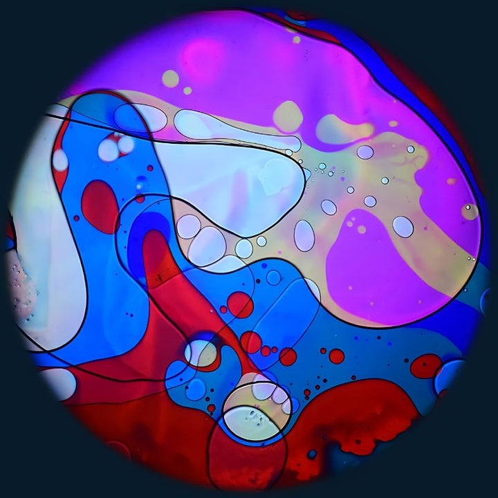 OPTIKinetics 6 inch Liquid Effect Wheel Candy Burst displaying its bright multi-colour oil-based lava lamp projection effect for sensory rooms and therapy spaces