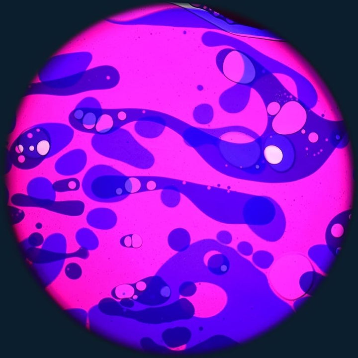 OPTIKinetics 6 inch Liquid Effect Wheel Pink Lady displaying its pink and purple-blue oil-based lava lamp projection for sensory rooms and therapeutic environments