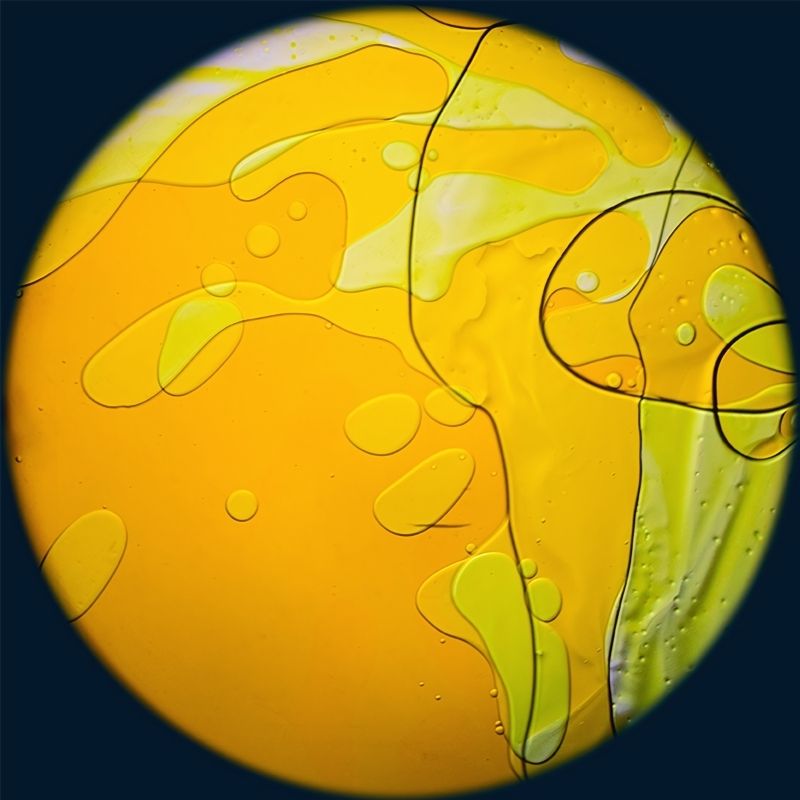 OPTIKinetics 6 inch Liquid Effect Wheel Sahara Sun showing the warm orange and yellow oil-based lava lamp projection for Solar LED sensory projectors and therapy spaces