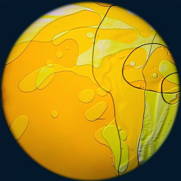 OPTIKinetics 6 inch Liquid Effect Wheel Sahara Sun showing the warm orange and yellow oil-based lava lamp projection for Solar LED sensory projectors and therapy spaces
