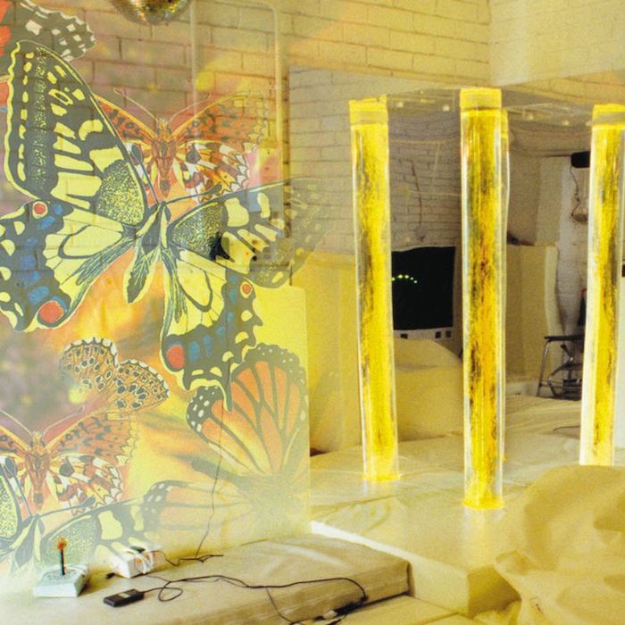 OPTIKinetics Solar 250 LED projector casting yellow butterfly projections, demonstrating the bright, high-colour-temperature output suitable for larger therapy rooms and classrooms