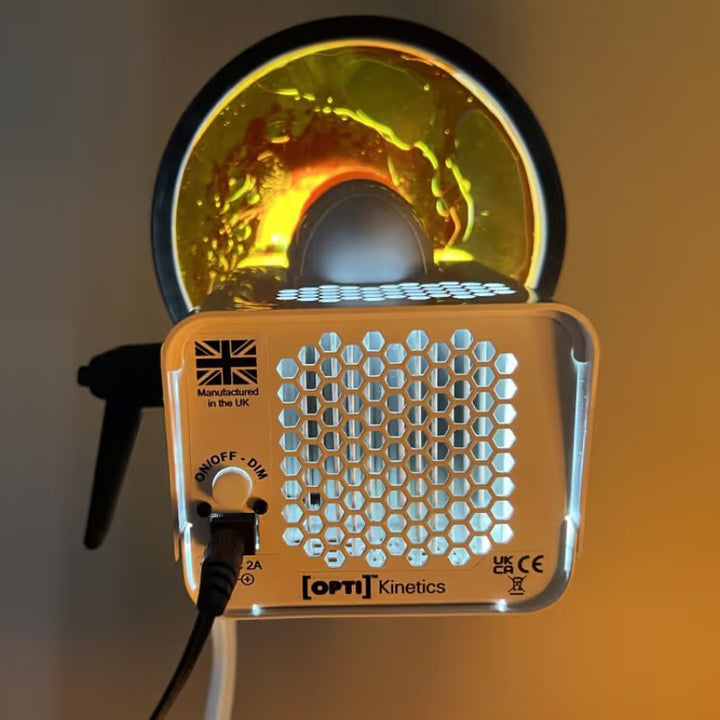 Rear panel of the OPTIKinetics Solar 80 sensory projector showing the on/off dim dial and a lit effect wheel projecting warm swirling colour for sensory rooms