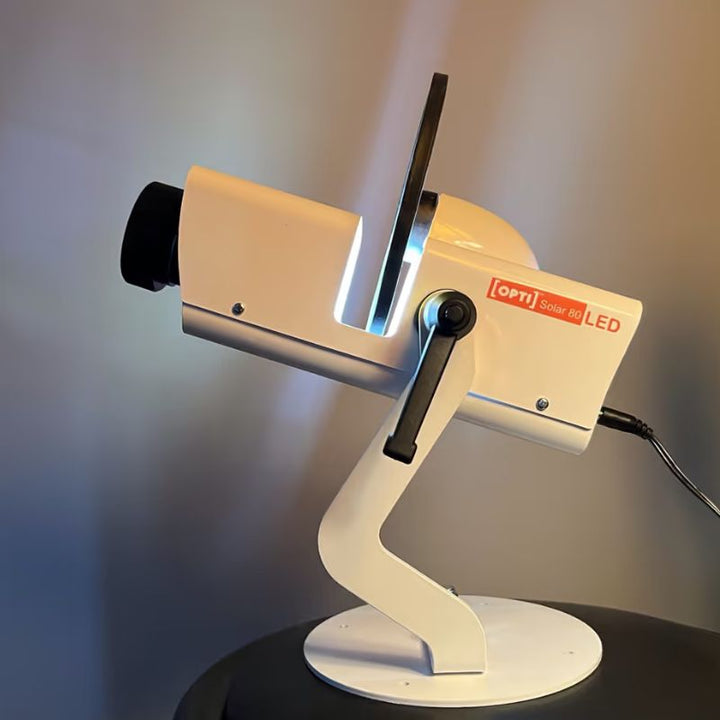 OPTIKinetics Solar 80 sensory projector powered on and casting light from its lens, a compact wifi controlled projector for North American sensory rooms