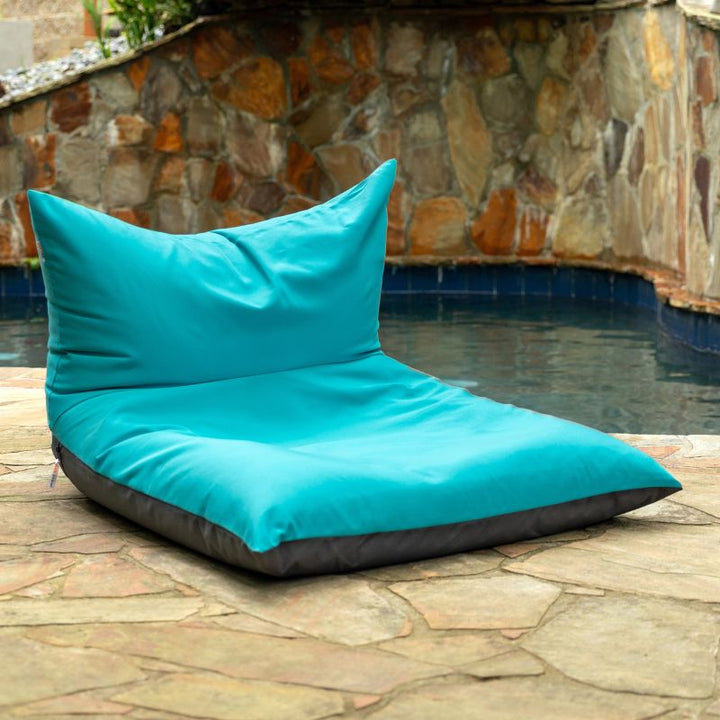 Jaxx Finster outdoor bean bag chair in Cancun Blue Sunbrella fabric, poolside