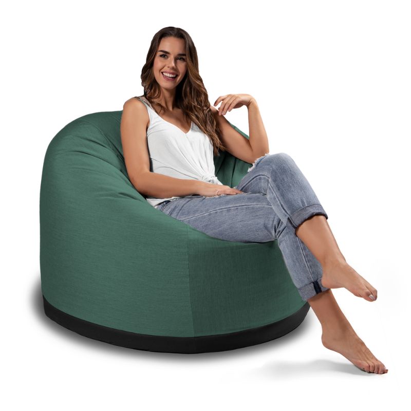 Woman relaxing in the Jaxx Palmetto outdoor bean bag chair in Breeze Sunbrella fabric