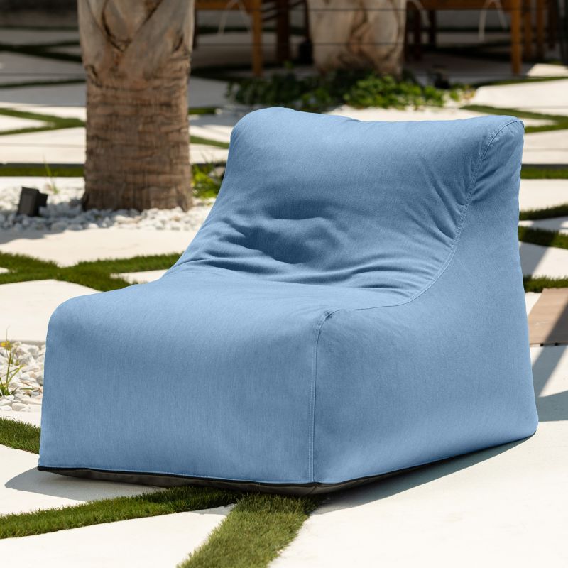 Jaxx Ponce Outdoor Bean Bag Chair in Sunbrella Ocean on a sunlit courtyard, a soft blue weather-resistant bean bag