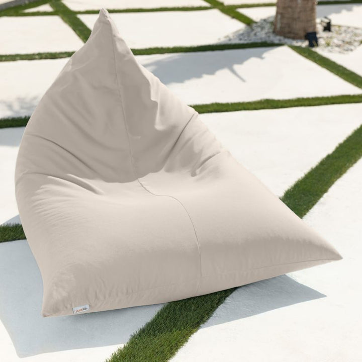 Jaxx Twist Outdoor Bean Bag Chair in White on a modern patio with turf inlays, a clean, light patio bean bag with a removable machine-washable cover