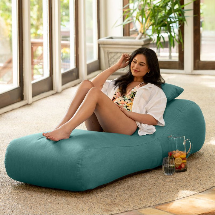Jaxx Arlo outdoor bean bag lounger in Breeze Sunbrella fabric styled in a sunroom for calming indoor-outdoor comfort