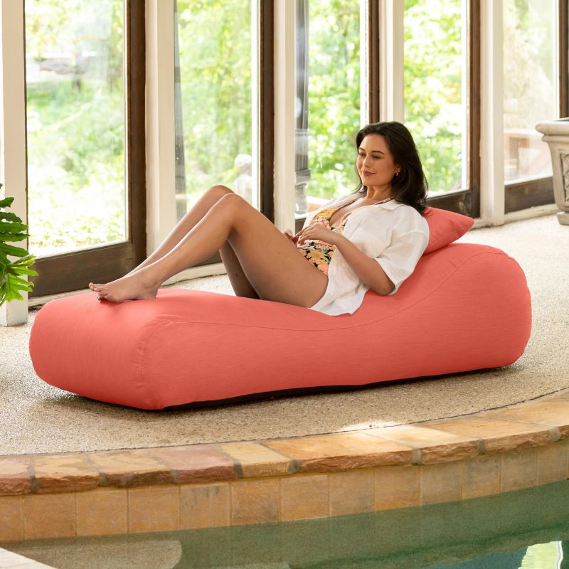 Jaxx Arlo outdoor bean bag lounger in flamingo Sunbrella fabric styled poolside for bright, relaxed lounging