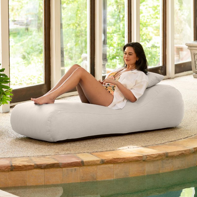 Jaxx Arlo outdoor bean bag lounger in Pearl Sunbrella fabric styled poolside for light, neutral comfort